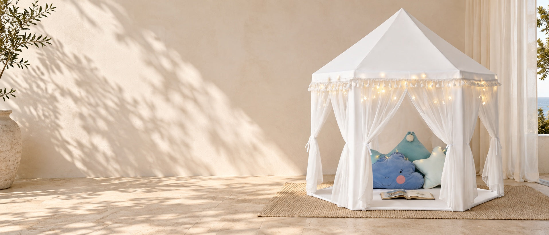 The white MonoBeach tassel tent on a quiet sunlit veranda